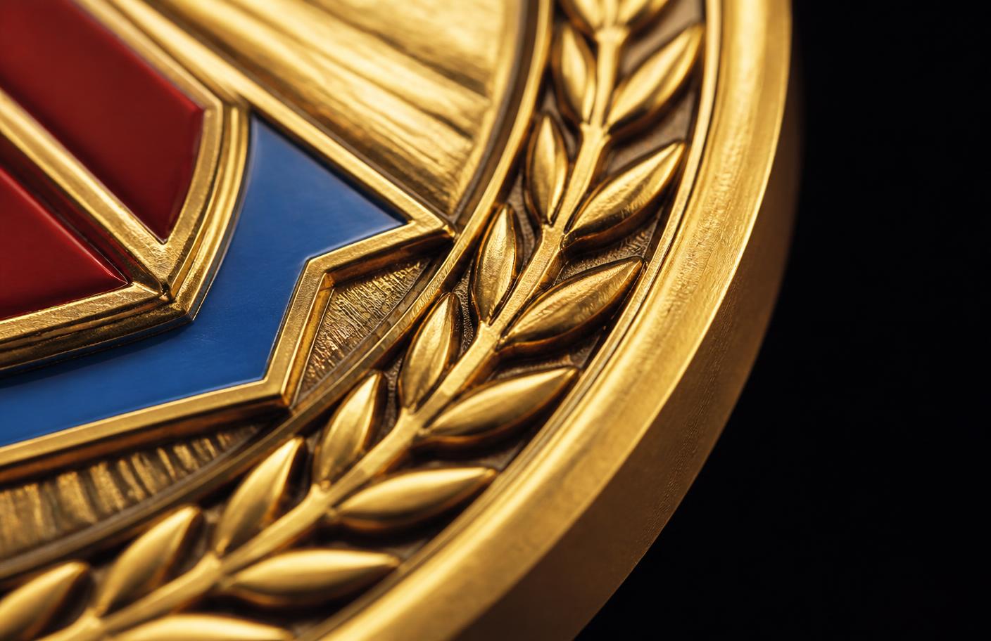 Macro close-up of a bespoke medal showing die-struck relief detail and enamel colour fill