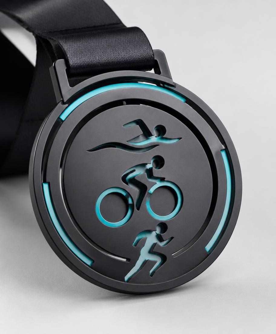 Custom triathlon finisher medal with race branding and printed ribbon